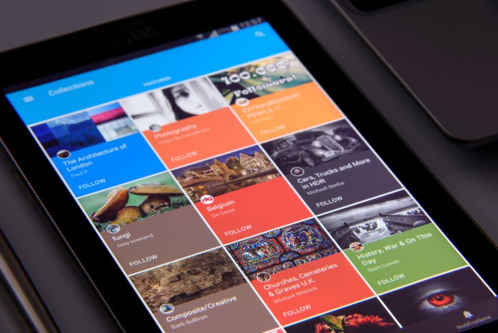 Close-up of a tablet displaying diverse content collections in a grid format. — Appwards