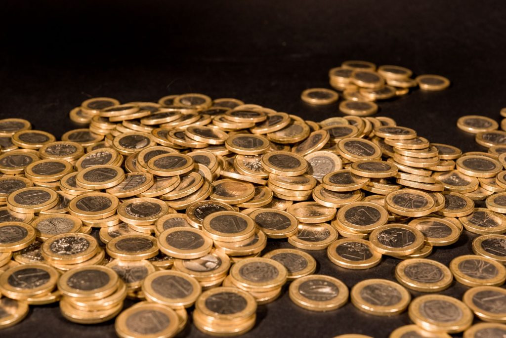 Close-up of a pile of Euro coins scattered on a black surface, representing wealth and finance. — Bomb Coin To Php