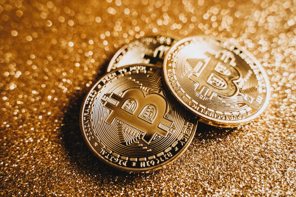 Close-up of shiny bitcoins on a gold glitter background, symbolizing cryptocurrency wealth. — Bomb Coin To Php