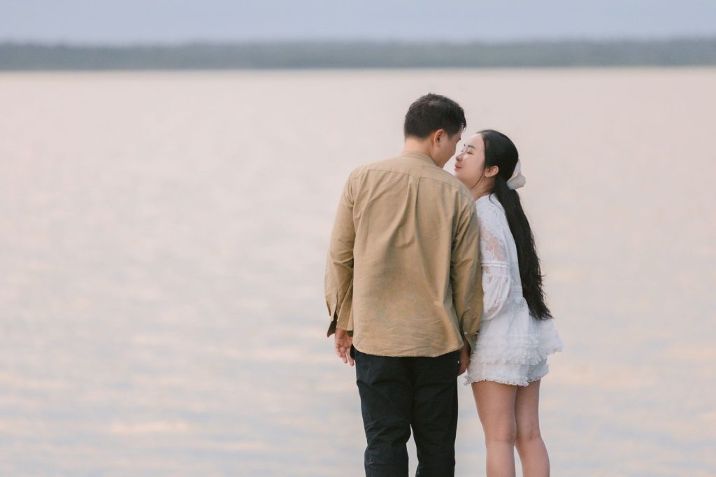 A couple embracing by a tranquil waterfront, symbolizing love and connection. — Couple Avatar
