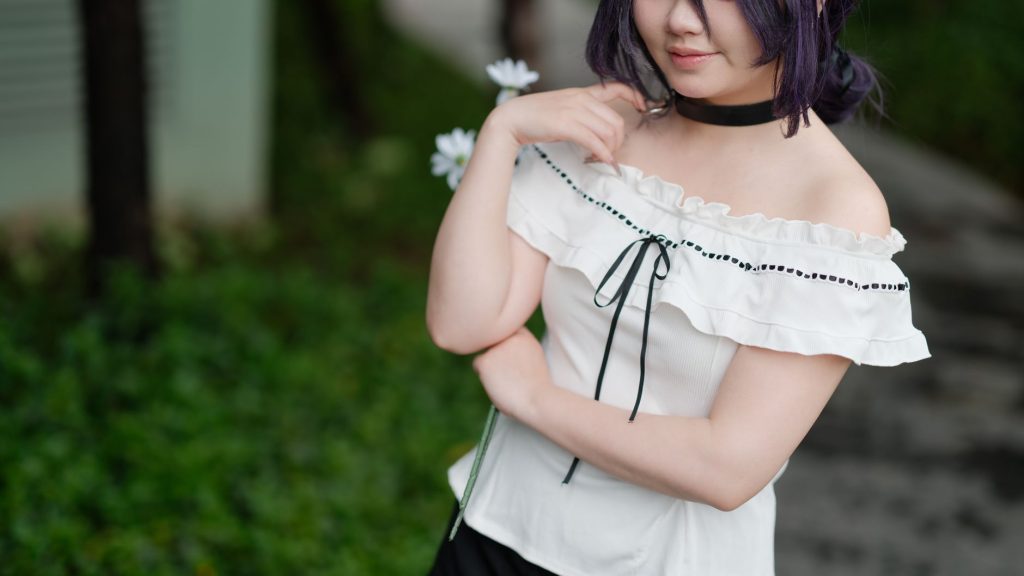 A young woman in a white off-shoulder dress with flowers, styled for cosplay, outdoors in Vietnam. — Hinata Tachibana