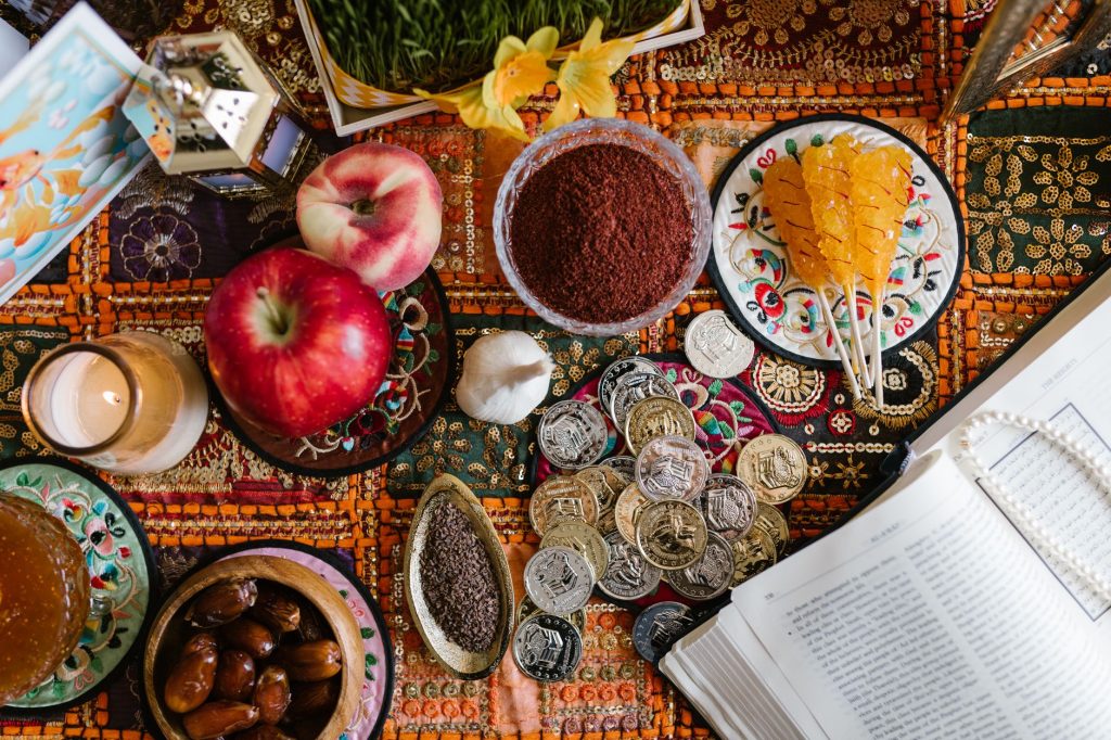 A colorful and festive Nowruz table setting with traditional foods, decorations, and symbols of Persian New Year. — Iyot