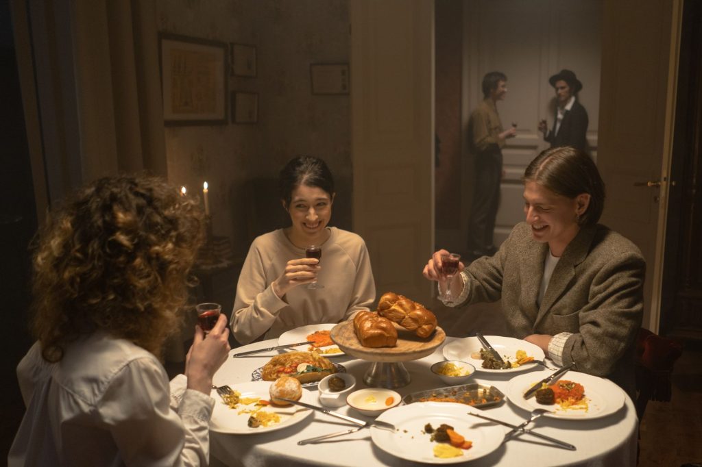 Smiling family enjoying a traditional Jewish meal with wine indoors. — Iyot