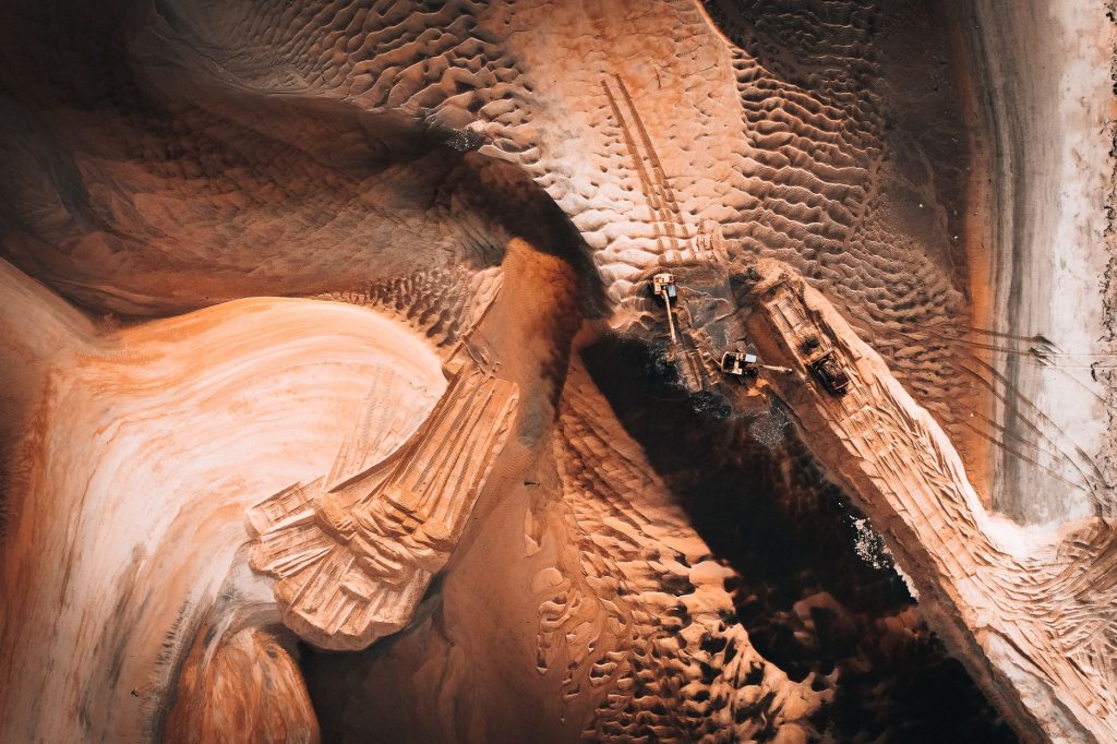 Stunning aerial shot of sand mining extraction in dynamic landscape. — Jakol