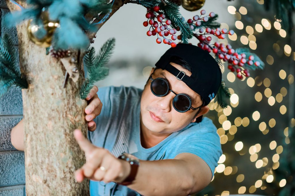 Festive portrait of a man with holiday decorations and bokeh lights. — Kathang Isip Lyrics