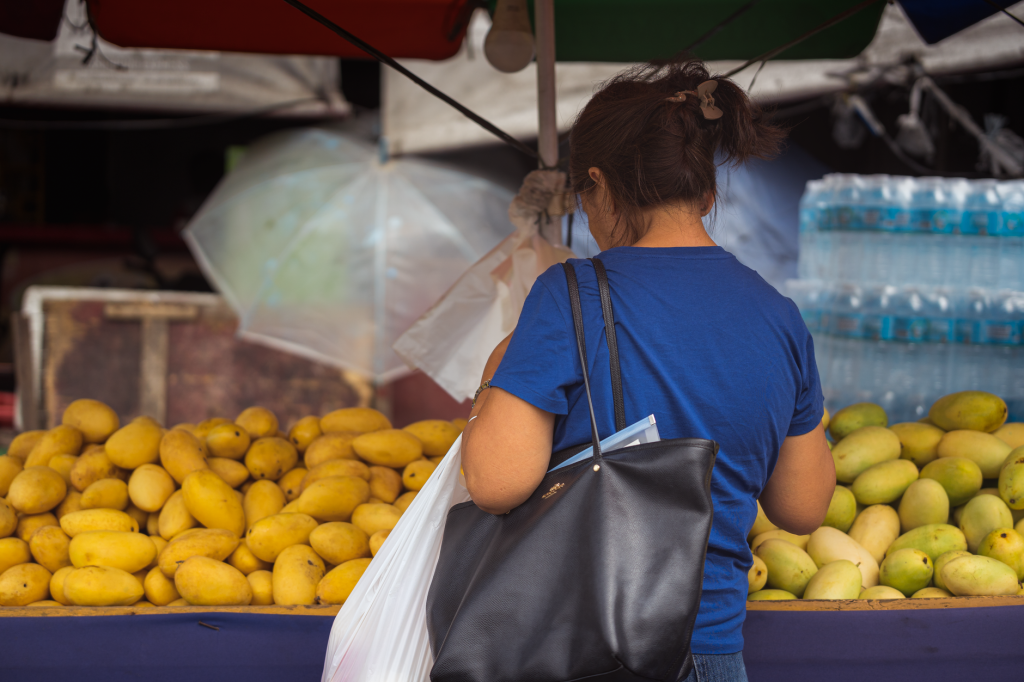 A woman buying fresh mangoes at a local market in Cebu City, Philippines. — Mang Kanor