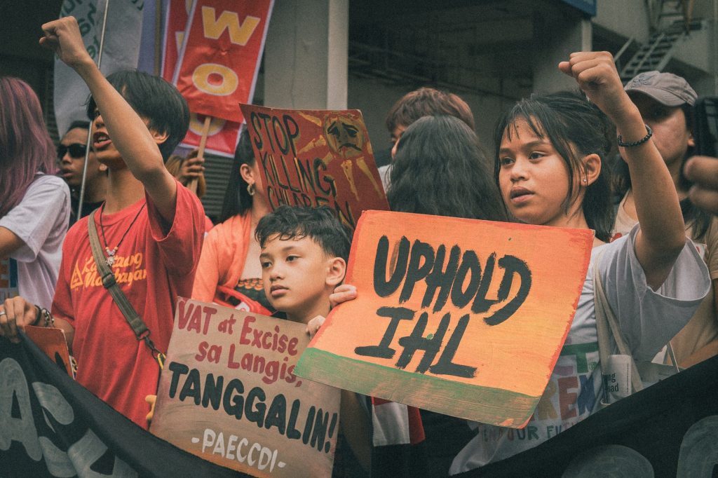A protest with young people holding signs advocating for human rights in Metro Manila. — Manila Exposed