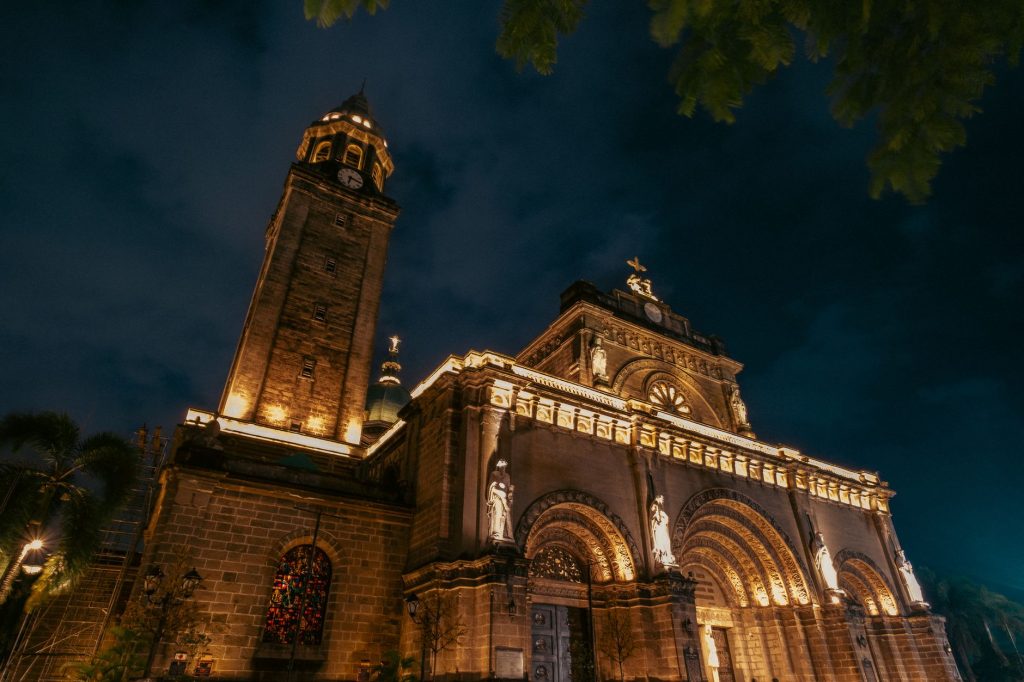 A dramatic night view of the illuminated Manila Cathedral showcasing its architectural beauty. — Manila Exposed