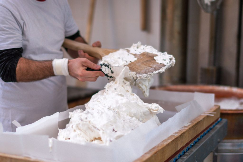 Artisan crafting nougat delicacy in Montélimar, France, highlighting traditional methods. — Panuto