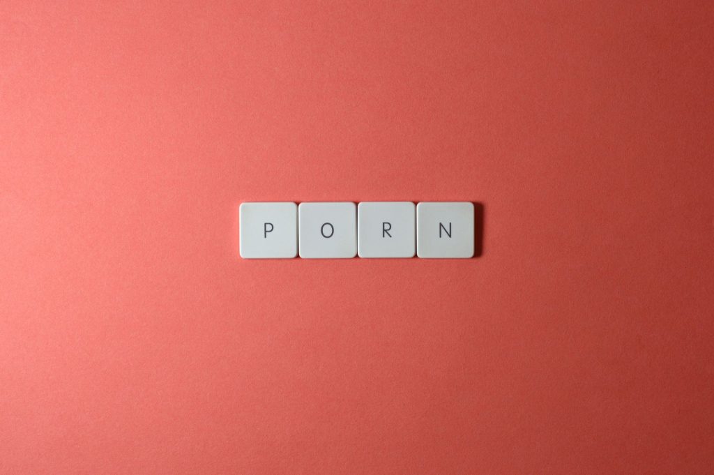 Minimalist image of keyboard keys spelling a word on a pink background. — Purn Hub