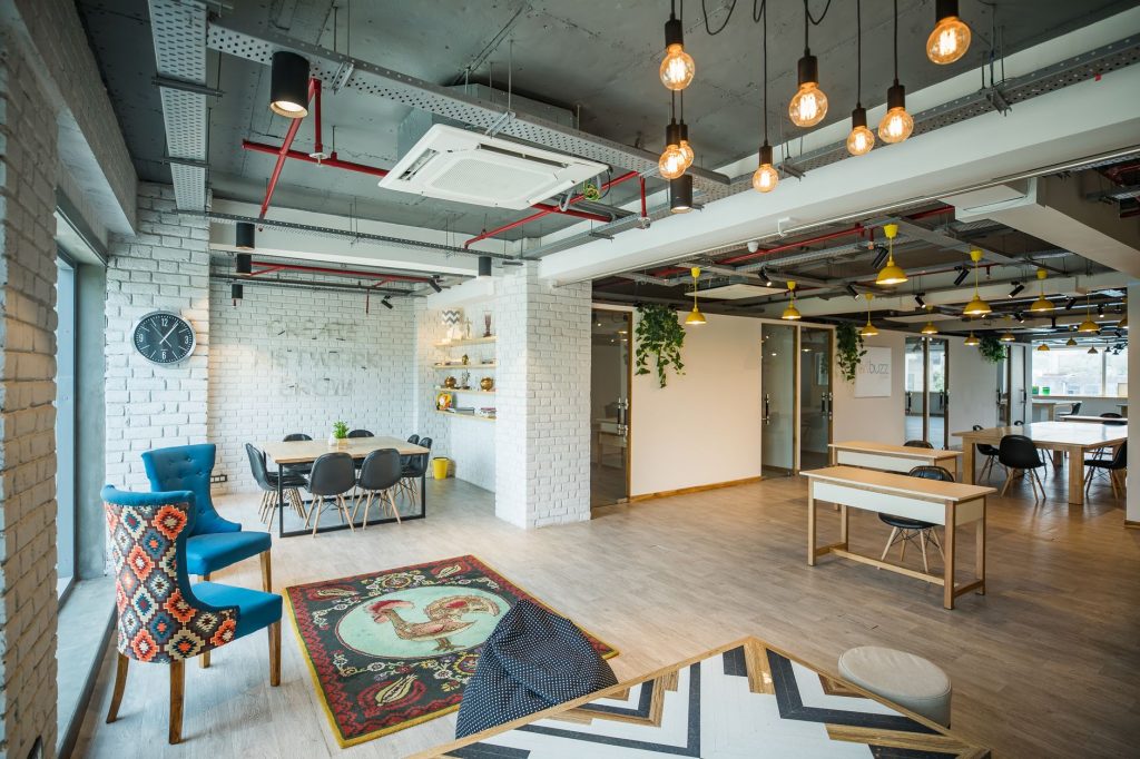 Spacious contemporary office interior featuring stylish furniture, unique decor, and ample lighting. — Purn Hub