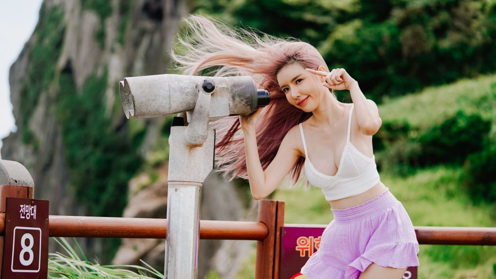 A woman with dyed hair poses near binoculars in a scenic outdoor setting, exuding fashion and vibrancy. — Rule 34 Kpop