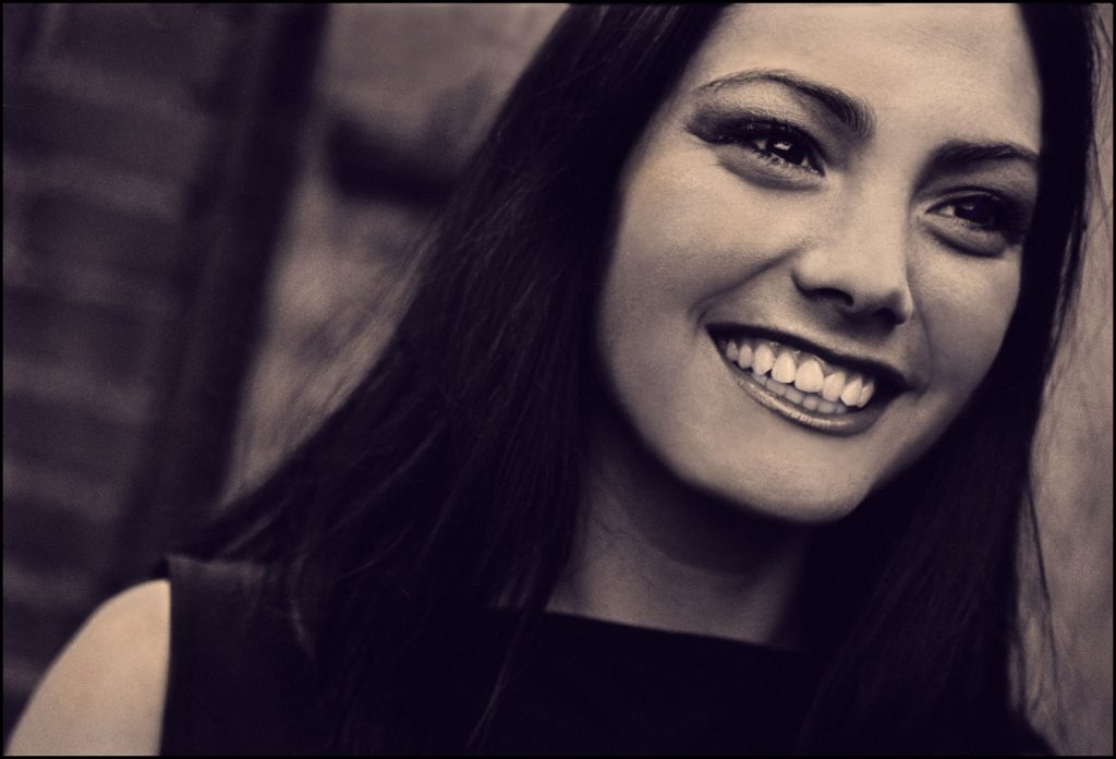 Candid portrait of a smiling woman with a vintage aesthetic, showcasing a joyful expression. — Samantha Lee Pettit Scandal