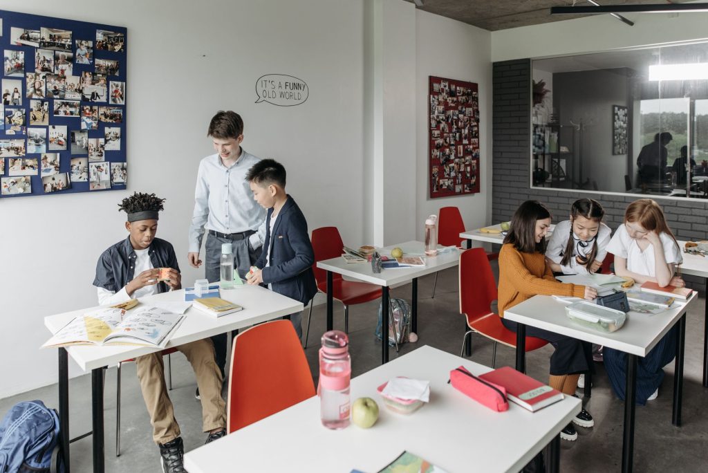 A diverse group of students engaged in a classroom setting, collaborating and studying. — Secret Class