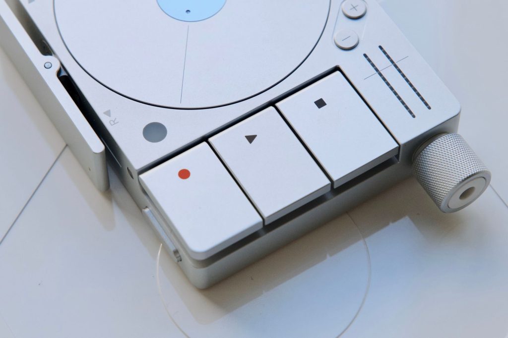 Close-up of a sleek, modern audio recorder with minimalistic design. — Ymp3