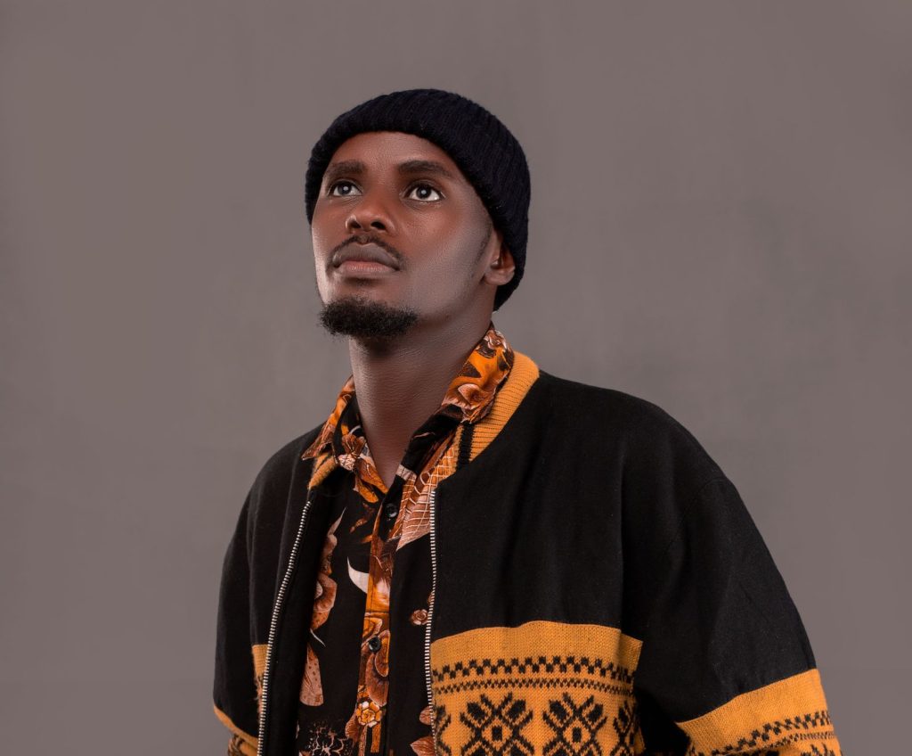 Portrait of a young man dressed in patterned attire looking upwards, exuding confidence and style. — Youjezz